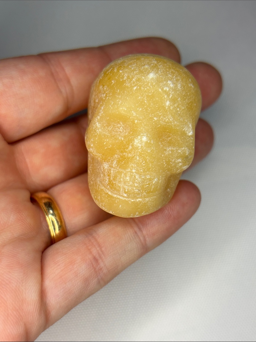 Yellow Banded Calcite Skull Palm Stone